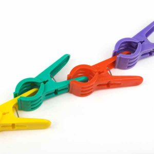 A picture of four bright pegs clipped to each other in a row