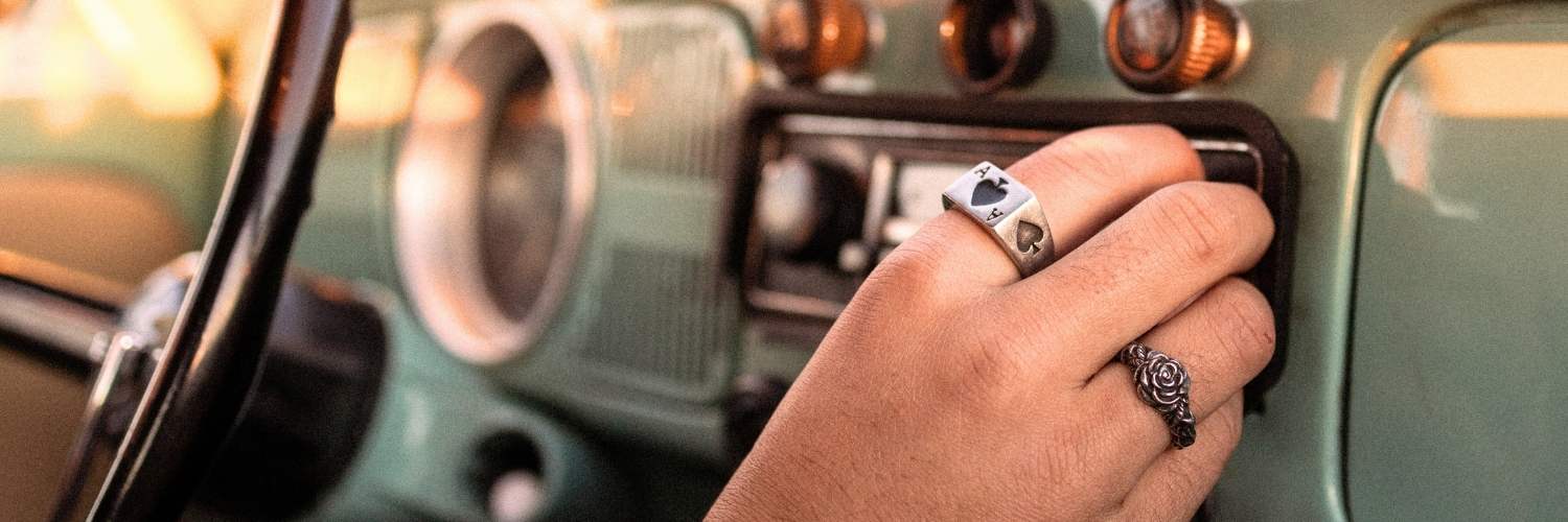 A vintage dashboard and persons hand